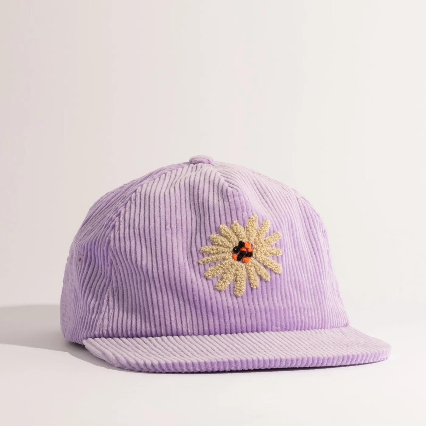 The Hayes Vintage Unstructured Cap in periwinkle corduroy with a daisy