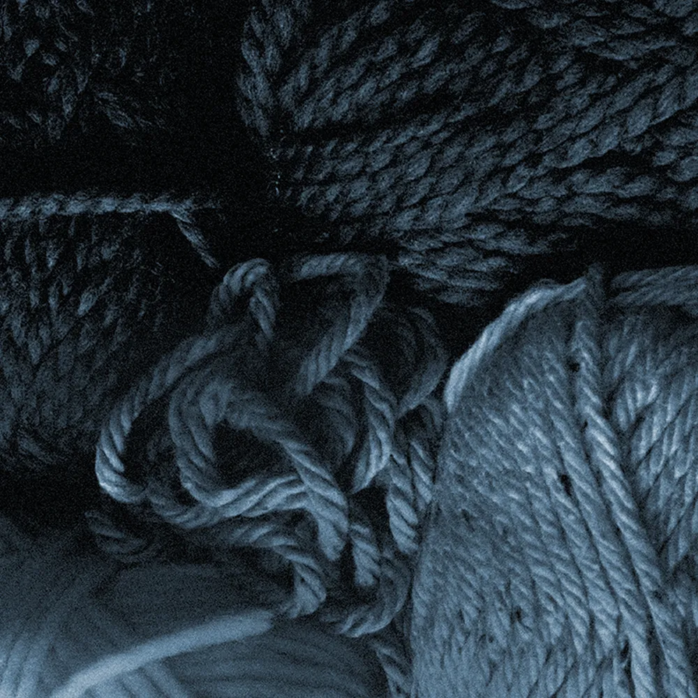 Close blue-toned photo of thick twisted yarn